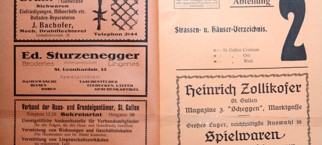 Abbildung 2: Werbekarton des Adressbuchs von 1924. Der &laquo;Zollibolli&raquo; wird in einigen St.Gallern sch&ouml;ne Kindheitserinnerungen wecken. Augenf&auml;llig ist links die thematische Vielfalt der Annoncen, die von Kleidung &uuml;ber den Grundeigent&uuml;merverband bis hin zu einer Drahtflechterei reicht.